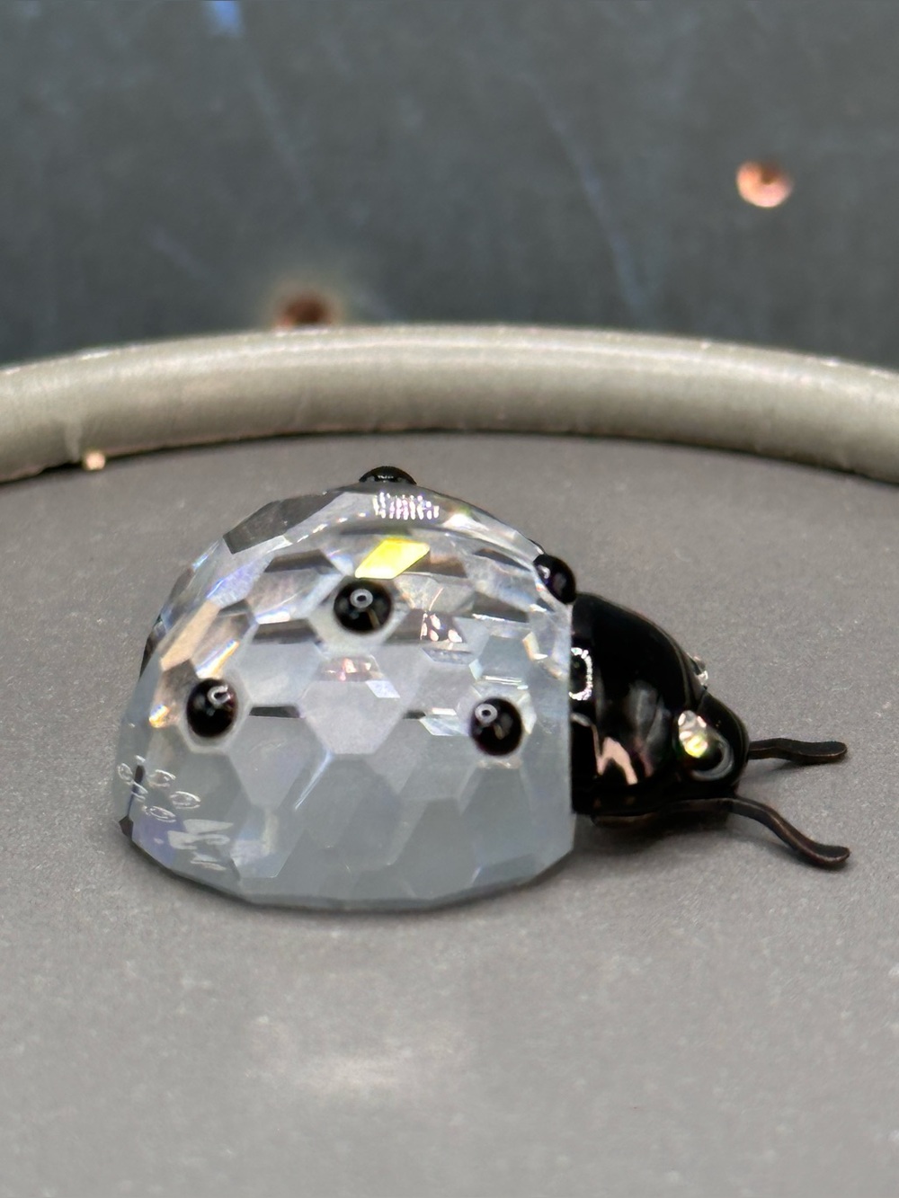 retired Swarovski Crystal Ladybug featuring a faceted clear crystal and metal